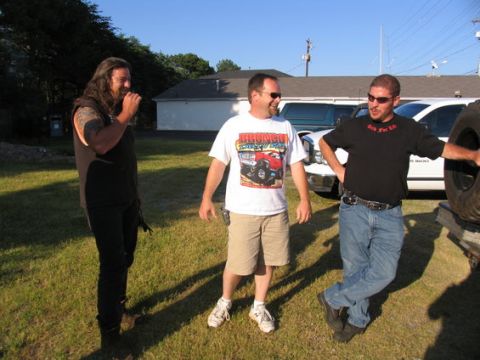 1995 Ford Bronco - Three men stand outdoors with vehicles in the background.