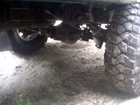1996 Ford Bronco - The underside of a vehicle is captured, showing a large tire and suspension details.