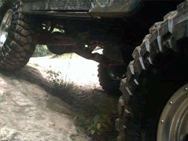 Undercarriage and large tires of an off-road vehicle on rough terrain