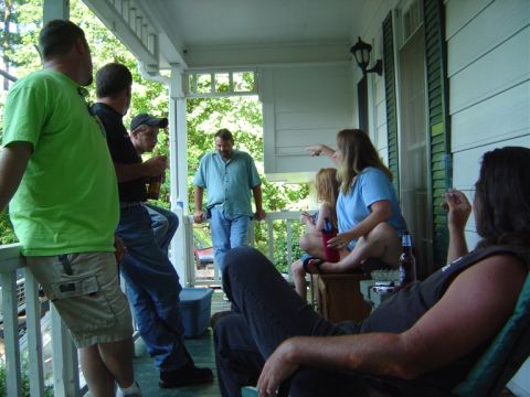 1986 Ford Bronco - People socializing on a porch during a gathering.