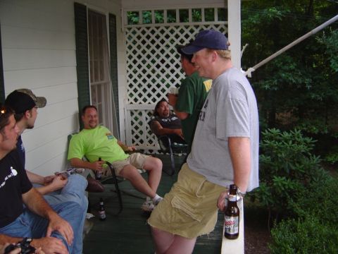 1986 Ford Bronco - Several men relax on a covered porch, enjoying beverages on a warm day.