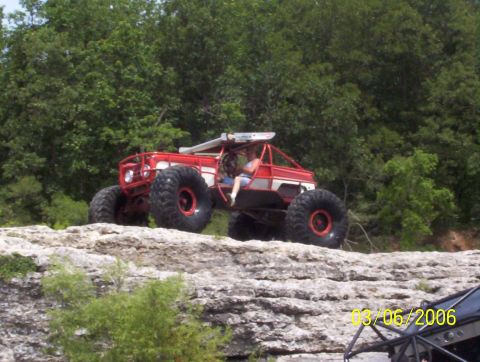 1991 Ford Bronco - A custom off-road buggy navigates a rocky landscape, with another vehicle partially visible in the foreground.