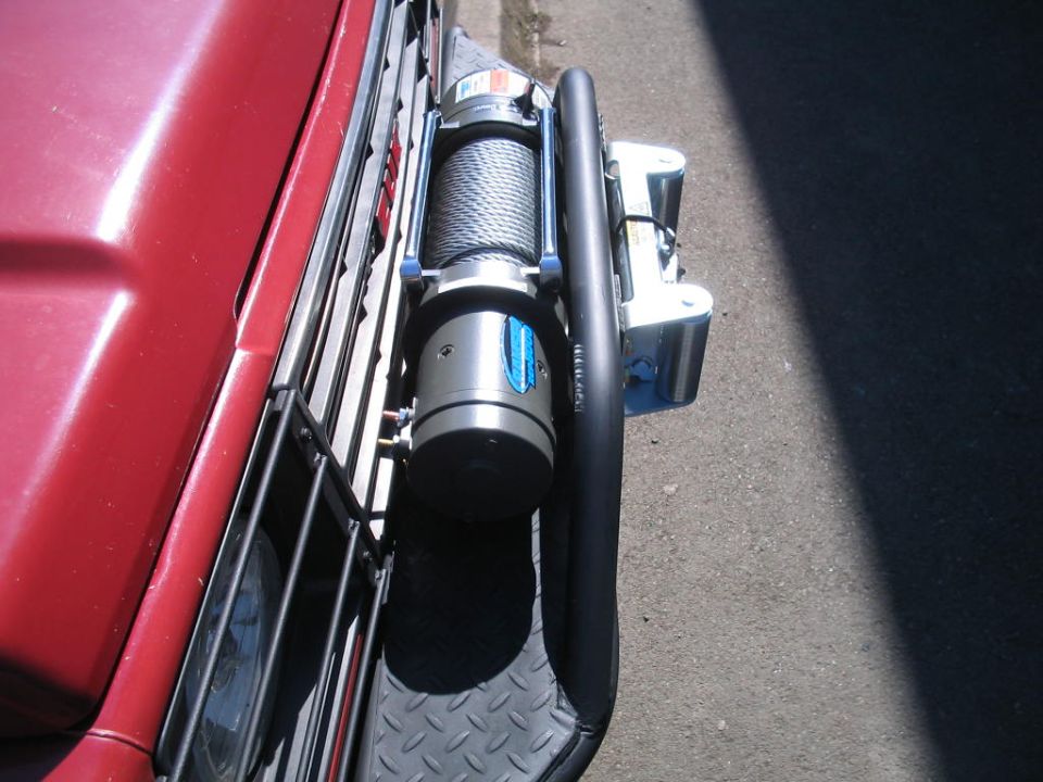 Red vehicle front with winch and brush guard