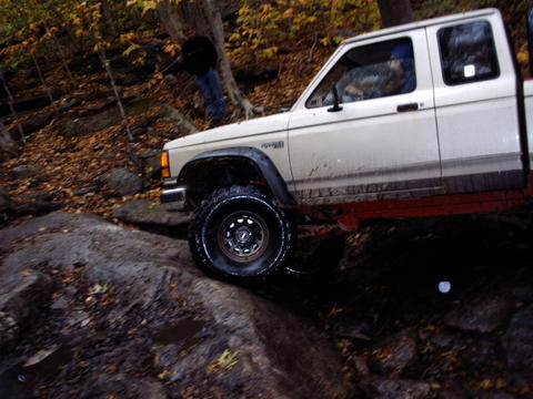 1990 Ford Ranger - A white Ford Ranger navigates a challenging rocky trail during autumn.