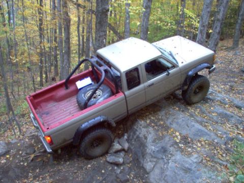 1990 Ford Ranger - A 1990 Ford Ranger navigates a rocky, wooded trail during autumn.