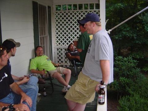 1995 Ford Bronco - A group of men relax on a porch, some holding bottles of beer.
