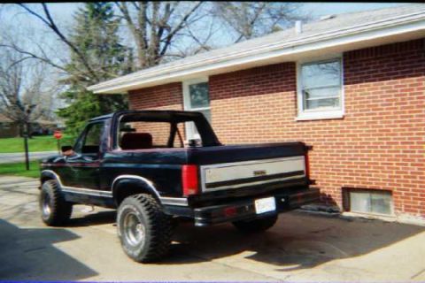 1986 Ford Bronco - This 1986 Ford Bronco is parked in a driveway beside a brick house.