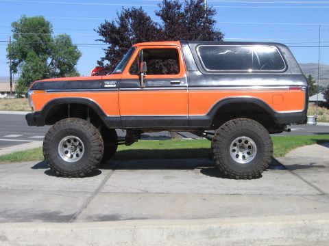 1979 Ford Bronco - This lifted 1979 Ford Bronco features a two-tone orange and gray paint scheme and aggressive off-road tires.