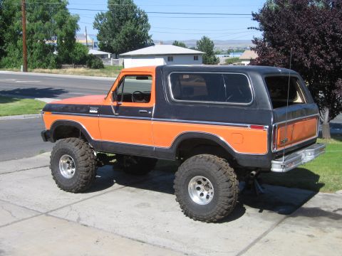 1979 Ford Bronco - This lifted Ford Bronco has a two-tone orange and black paint scheme and aggressive off-road tires.