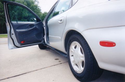 1997 Ford Taurus - Exterior shot of a 1997 Ford Taurus with the driver's side door ajar.