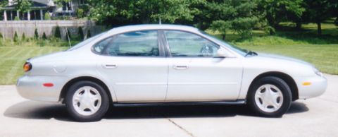 1997 Ford Taurus - This silver 1997 Ford Taurus sedan is shown from the side, parked outdoors.