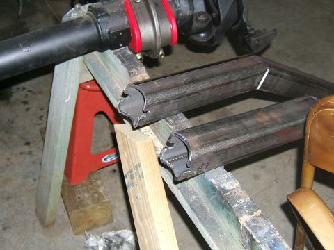 1993 Ford Bronco - Custom metal tubing and a vehicle axle part are staged on sawhorses for modification.