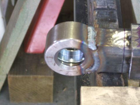 1993 Ford Bronco - A close-up view of a metal component, possibly a part of machinery, with a bearing visible inside a cylindrical housing.