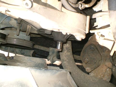 1989 Ford Bronco - Close-up of engine components, including a pulley system and a water pump.