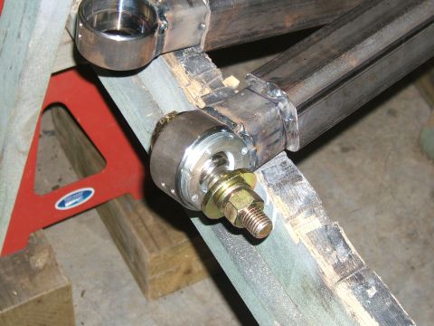 1993 Ford Bronco - A close-up view of a vehicle's suspension system component, showing metal tubing and hardware.
