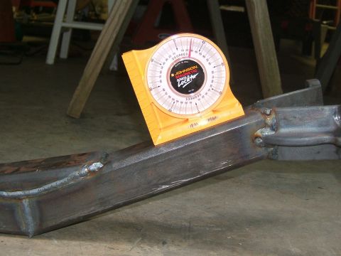 1993 Ford Bronco - An angle gauge is used to measure the angle of a metal frame, possibly for vehicle modification.