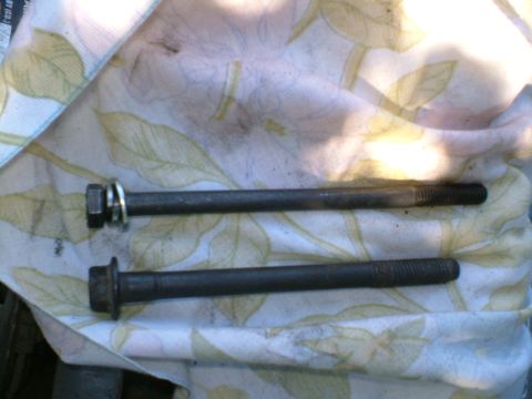 1989 Ford Bronco - Two bolts are shown on a cloth, possibly for a vehicle repair or installation.