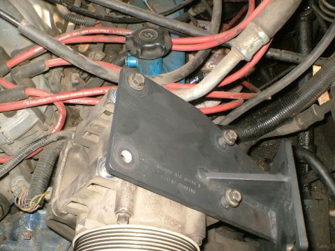 1989 Ford Bronco - Close-up view of engine components, including an alternator and various hoses and wires.