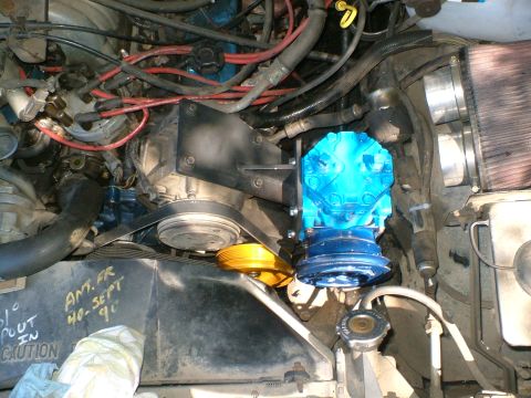 1989 Ford Bronco - Engine bay detail showing a blue compressor and yellow pulley, with handwritten notes on the radiator support.