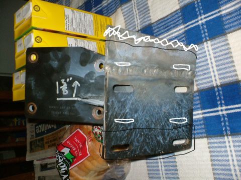 1989 Ford Bronco - Metal bracket with white markings and welded sections, possibly for vehicle installation.