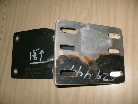 1989 Ford Bronco - Two metal brackets are shown, one black and one raw, both with handwritten markings.