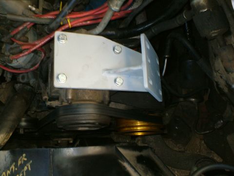 1989 Ford Bronco - Close-up view of engine components, including a newly installed bracket and pulleys.