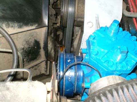 1989 Ford Bronco - Close-up of an engine compressor and belt system, with Supermotors.net branding.
