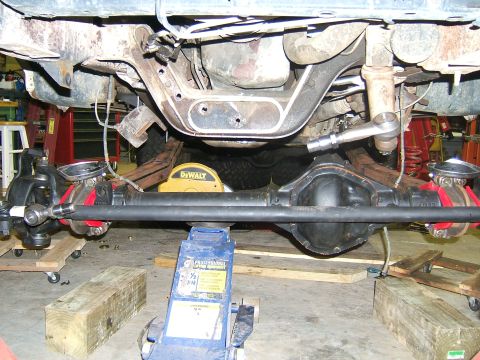 1993 Ford Bronco - Undercarriage view of a 1993 Ford Bronco, showing the front axle and suspension system.