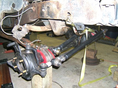 1993 Ford Bronco - Close-up view of the front suspension and steering linkage, likely during a modification or repair.