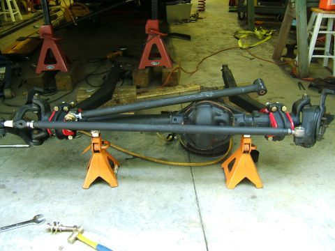 1993 Ford Bronco - Front axle assembly on jack stands, ready for installation or modification.