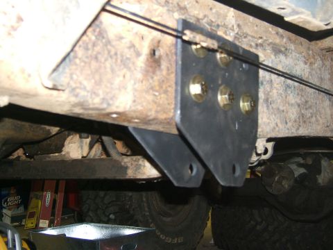 1993 Ford Bronco - Close-up of a custom bracket attached to a vehicle's frame, showing brake lines and bolts.