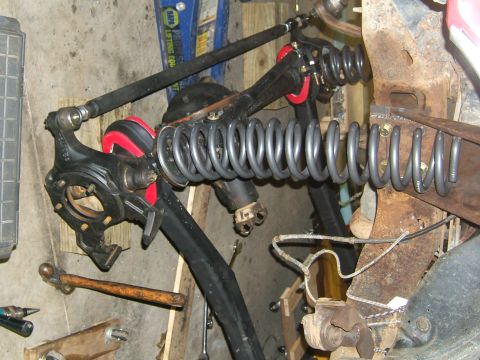 1993 Ford Bronco - Workshop photo of disassembled Ford Bronco front suspension parts, including springs and steering linkage.