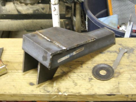 1993 Ford Bronco - A custom-welded metal part sits on a workbench, accompanied by a screen and a wrench.