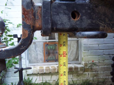 1987 Ford Bronco - A tape measure is used to measure the height of a trailer hitch.