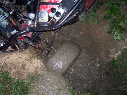 1989 Ford Bronco II - This off-road vehicle appears to be stuck in a muddy ditch.