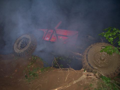 1989 Ford Bronco II - Smoke billows over green foliage in an outdoor scene.