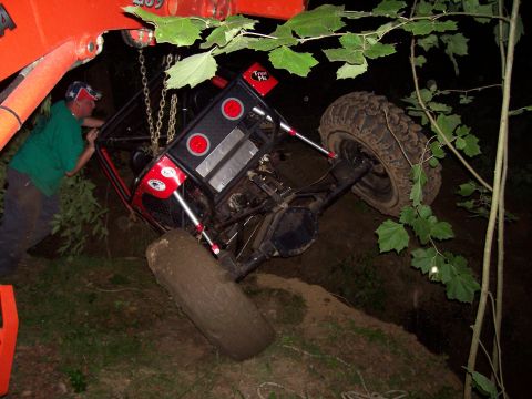 1989 Ford Bronco II - A custom off-road buggy is being hoisted by a crane after getting stuck in the mud.