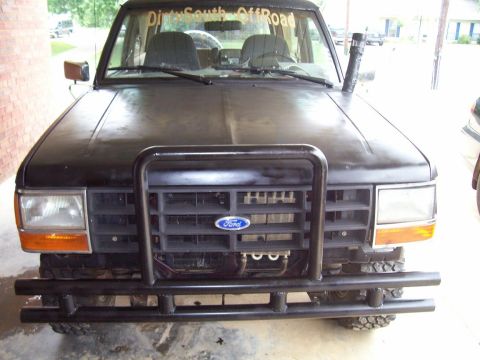 1989 Ford Bronco II - Front view of a black 1989 Ford Bronco II with off-road modifications.