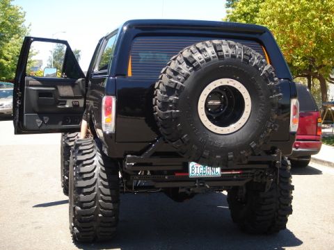 1991 Ford Bronco - This heavily modified SUV features massive off-road tires and a spare tire carrier on the rear.