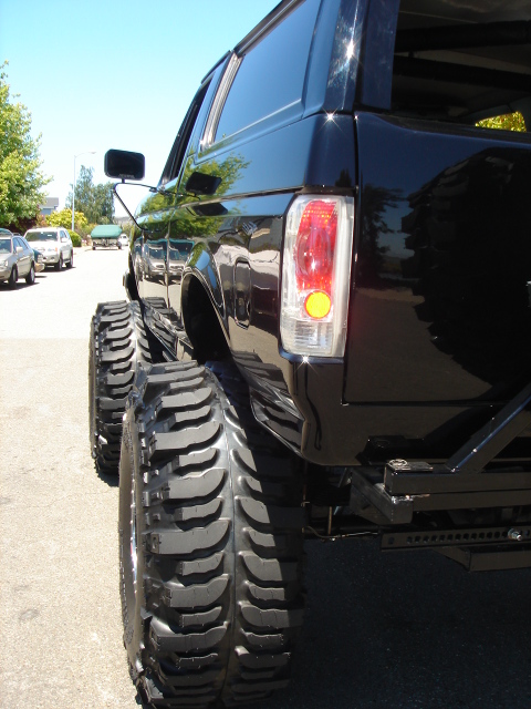 1991 Ford Bronco - This black SUV, likely a 1992 model, is heavily modified with large tires and a lifted suspension.