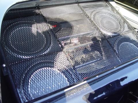 1991 Ford Bronco - A custom speaker enclosure several subwoofers is visible, protected by a metal grille.