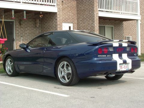 1995 Ford Probe - The rear of a blue 1995 Ford Probe GT is shown with white racing stripes and a spoiler.