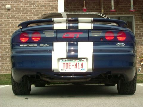 1995 Ford Probe - The rear of a blue 1995 Ford Probe GT is shown, white racing stripes and a Wisconsin license plate.
