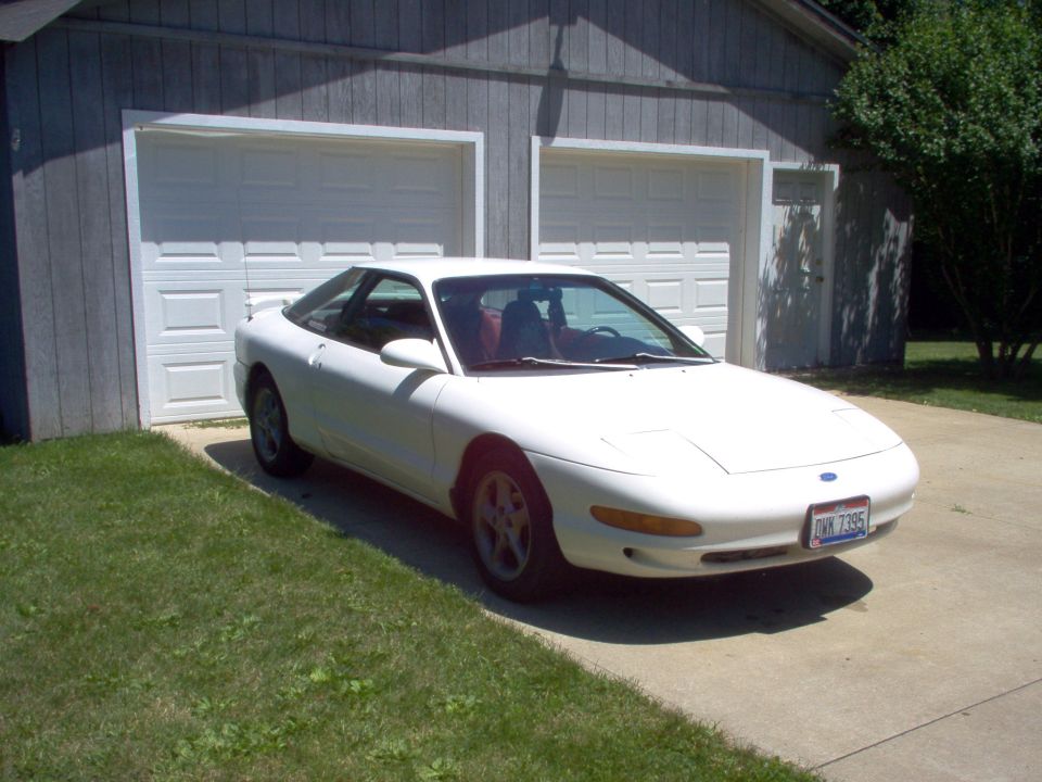 1993 Ford Probe parked in front of a two-car garage