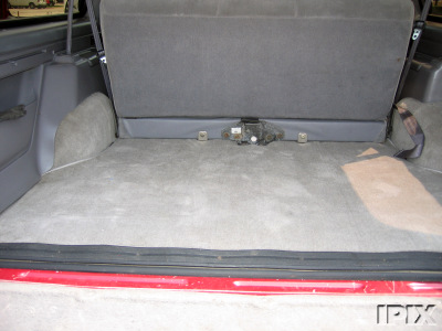 1995 Ford Bronco - The cargo area of a 1995 Ford Bronco, showing the carpeted floor and rear seat.
