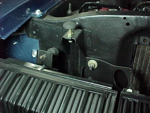 1968 Mercury Cougar - Close-up of the engine bay of a blue 1968 Mercury Cougar, showing the VIN plate and radiator grille.