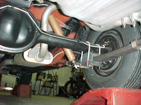 1968 Mercury Cougar - Underside view of a car's rear axle, leaf springs, and exhaust system, showing suspension components.