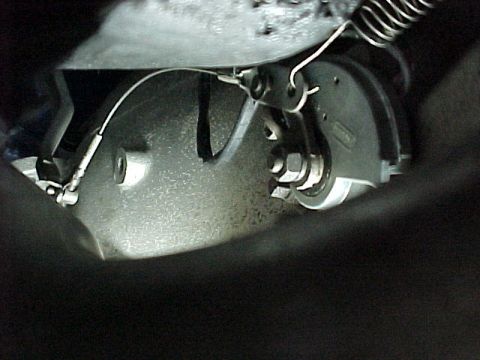 1968 Mercury Cougar - Close-up view of a vehicle's throttle linkage system, showing cables and springs.