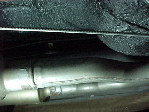 1968 Mercury Cougar - Close-up view of the exhaust system and undercarriage components of a vehicle.