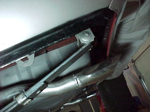 1968 Mercury Cougar - Close-up view of a vehicle's exhaust pipe system, showing a chrome tip and mounting hardware.